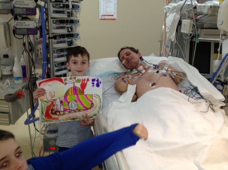 Ben showing Matthew his artwork from school. Afternoon visits to ICU and then rehab were part of the routine for nine months.