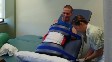 Jacqui (Wright, Matthew's physiotherapist) gets Matthew ready to test pressure on his stumps for the first time. 