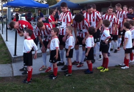 Will was very excited to lead the junior team out to present a cheque to Matthew after the Holland Park Hawks raised $14 000.